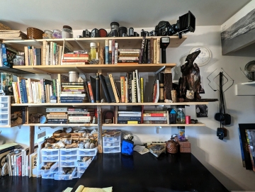 cameras and darkroom equipment from my very first Brownie Hawkeye to my best Mamiya 67 studio camera plus more books on anthropology, history, biology, art, graphology, and misc general knowledge books.  Top shelf also has a number of books from the 1800s.